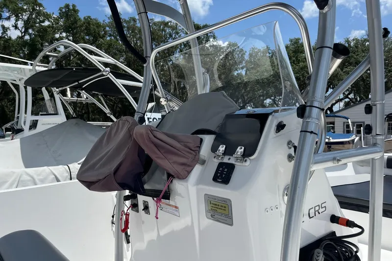 Slide: The Image of 2022 K2 Marine boat dashboard with steering wheel and controls, outdoors under blue sky. - 8