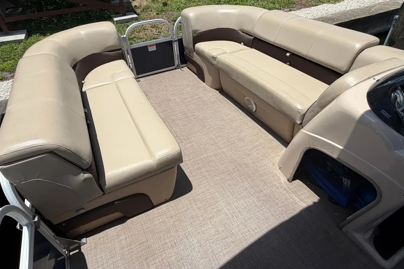 Slide: The Image of 2019 Sun Tracker Party Barge 20 DLX interior with beige seating and spacious deck. - 17