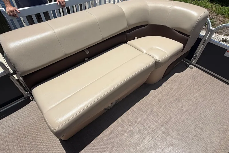 Slide: The Image of 2019 Sun Tracker Party Barge 20 DLX beige seating on pontoon boat deck. - 20