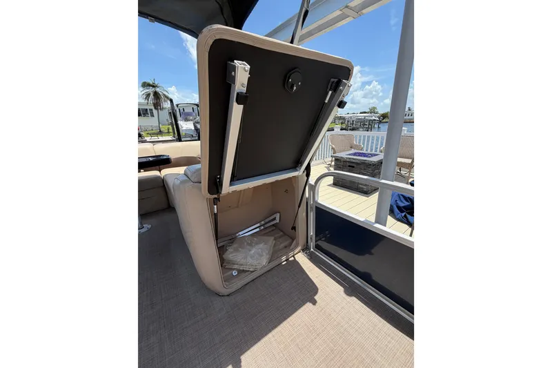 Slide: The Image of 2019 Sun Tracker Party Barge 20 DLX with open storage compartment on deck. - 22