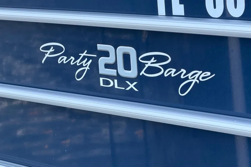 Slide: The Image of 2019 Sun Tracker Party Barge 20 DLX logo on blue background. - 23