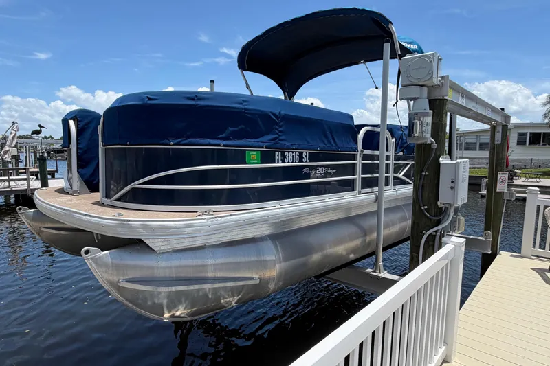 Slide: The Image of 2019 Sun Tracker Party Barge 20 DLX pontoon boat docked with blue cover. - 3