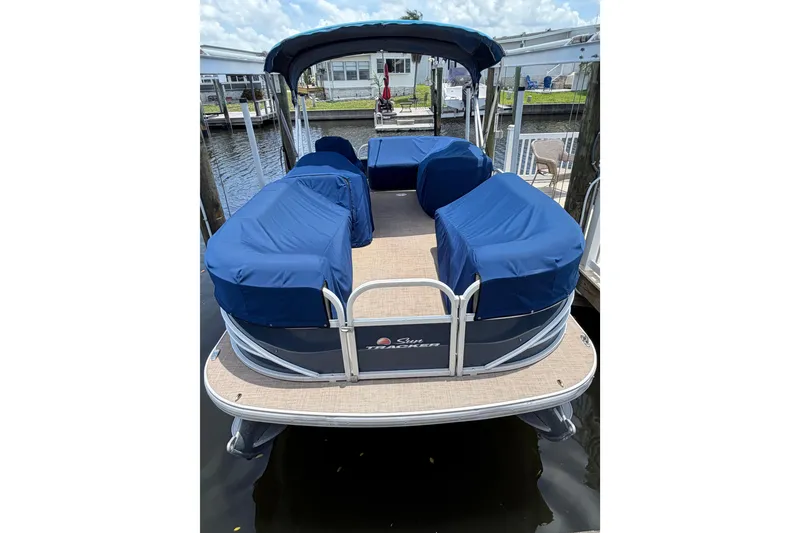 Slide: The Image of 2019 Sun Tracker Party Barge 20 DLX pontoon boat with blue covers docked. - 4