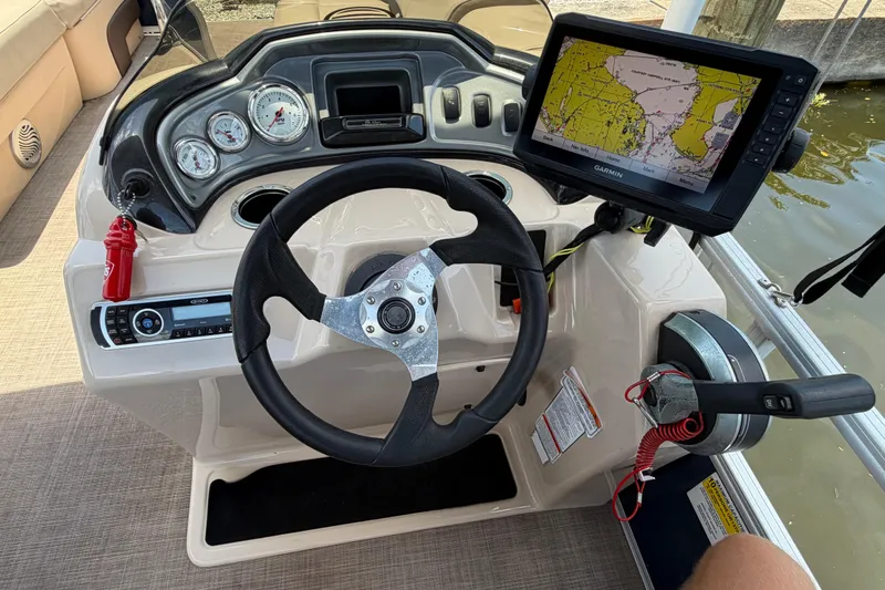 Slide: The Image of 2019 Sun Tracker Party Barge 20 DLX helm with steering wheel and Garmin navigation display. - 7