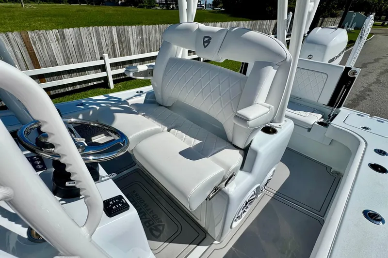Slide: The Image of 2023 Barker Boatworks 26 Open with white cushioned seating and steering wheel. - 10