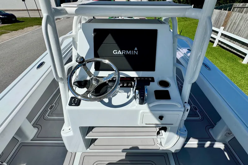 Slide: The Image of 2023 Barker Boatworks 26 Open helm with Garmin navigation system and steering wheel. - 11