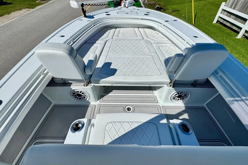 Slide: The Image of 2023 Barker Boatworks 26 Open interior with cushioned seating and modern design. - 14