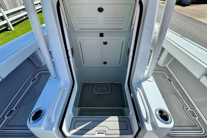 Slide: The Image of 2023 Barker Boatworks 26 Open interior storage compartment with sleek design and cup holders. - 16