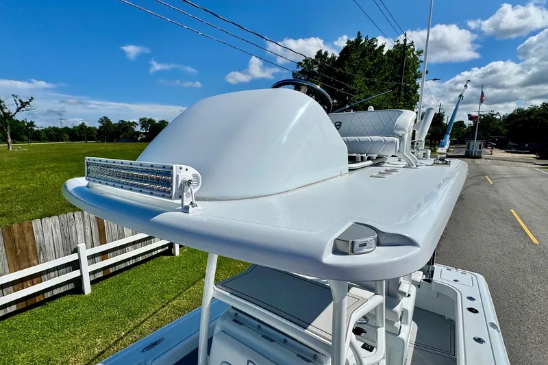 Slide: The Image of 2023 Barker Boatworks 26 Open, showcasing sleek design and advanced features under a clear sky. - 17