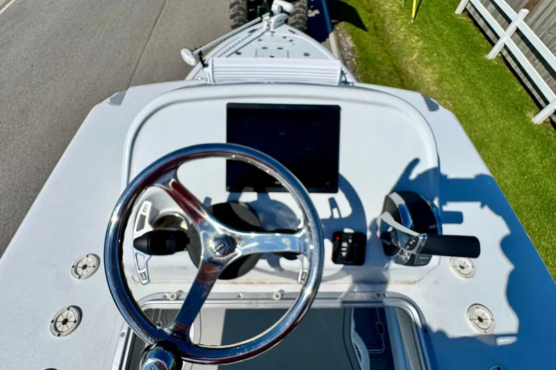 Slide: The Image of 2023 Barker Boatworks 26 Open helm with steering wheel and controls. - 18