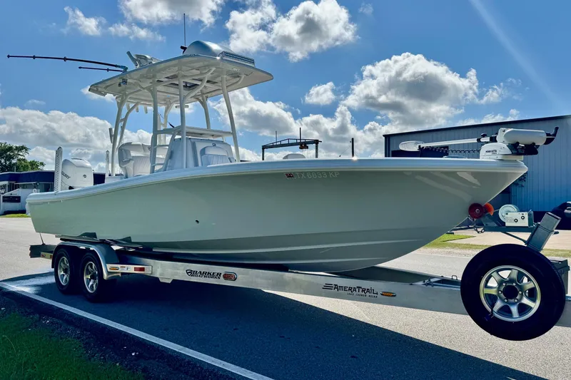 Slide: The Image of 2023 Barker Boatworks 26 Open on trailer under blue sky with clouds. - 5