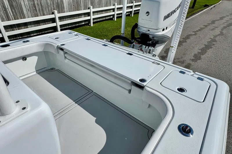 Slide: The Image of 2023 Barker Boatworks 26 Open deck with Mercury engine, white finish, and storage compartments. - 7