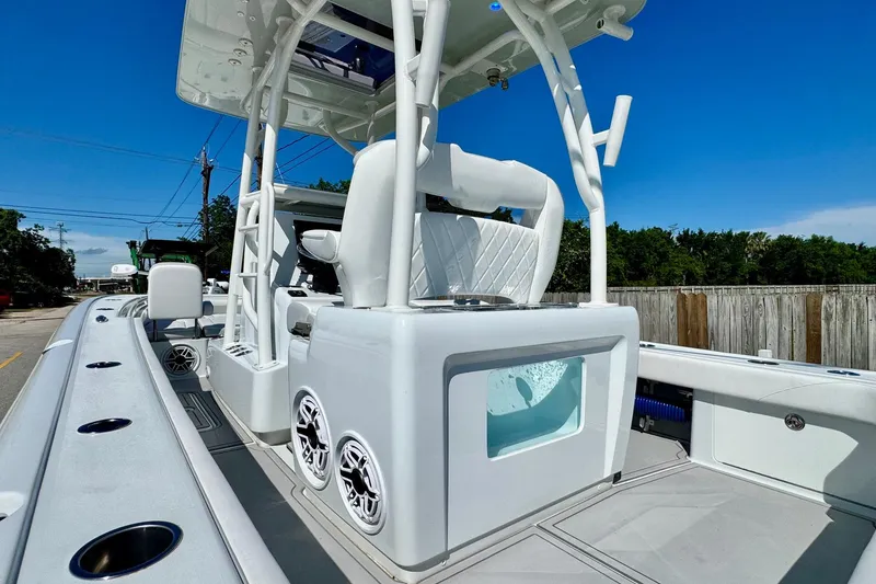 Slide: The Image of 2023 Barker Boatworks 26 Open, sleek design, white interior, outdoor setting. - 9