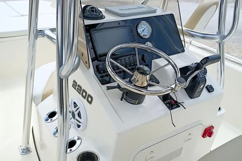 Slide: The Image of 2023 Bulls Bay 2200 boat console with steering wheel, gauges, and controls. - 11