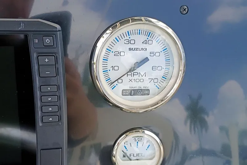 Slide: The Image of Dashboard of 2023 Bulls Bay 2200 boat with Suzuki RPM and fuel gauges. - 12