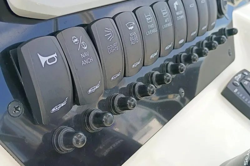 Slide: The Image of Control panel of 2023 Bulls Bay 2200 boat with labeled switches. - 15