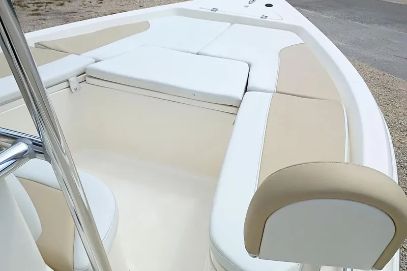 Slide: The Image of 2023 Bulls Bay 2200 boat interior with beige and white cushioned seating. - 17