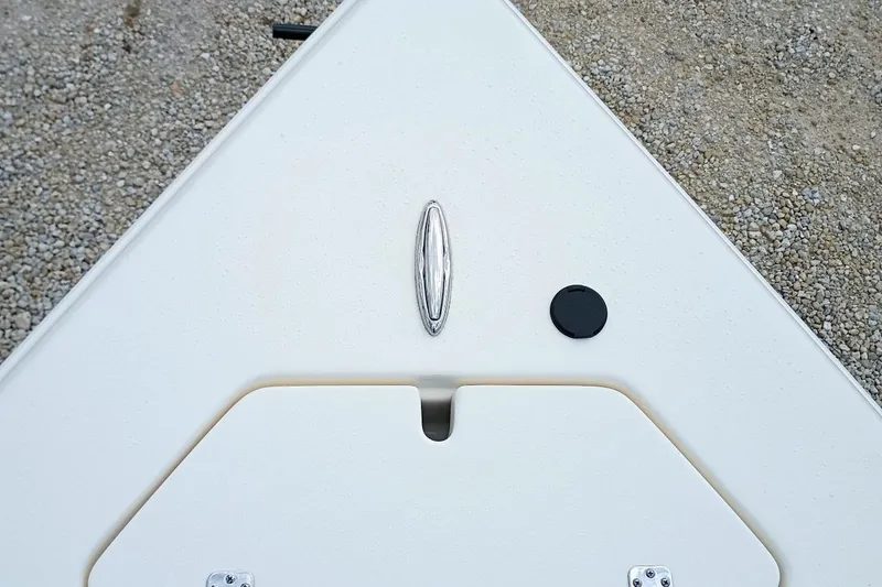 Slide: The Image of Bow of 2023 Bulls Bay 2200 boat with cleat and hatch on gravel surface. - 20