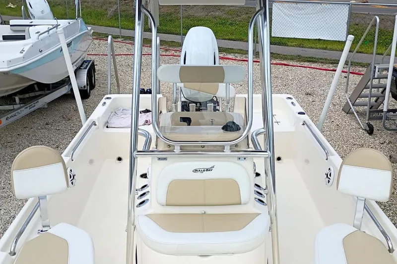 Slide: The Image of 2023 Bulls Bay 2200 boat interior with beige seating and steering console. - 23
