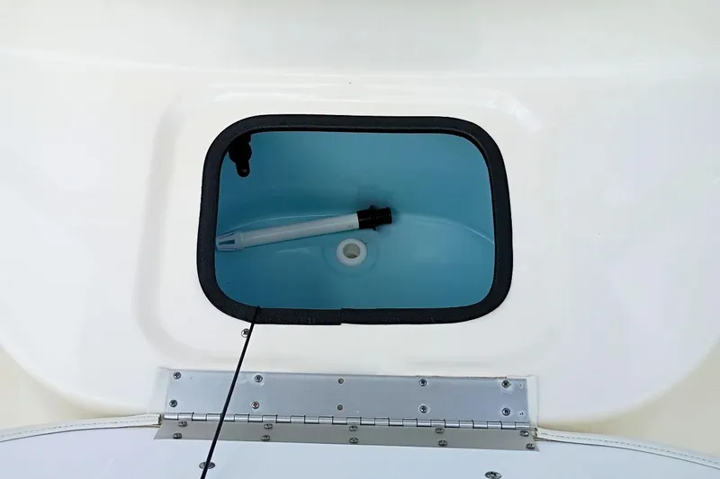 Slide: The Image of Livewell compartment in 2023 Bulls Bay 2200 boat, featuring a blue interior and secure lid. - 25