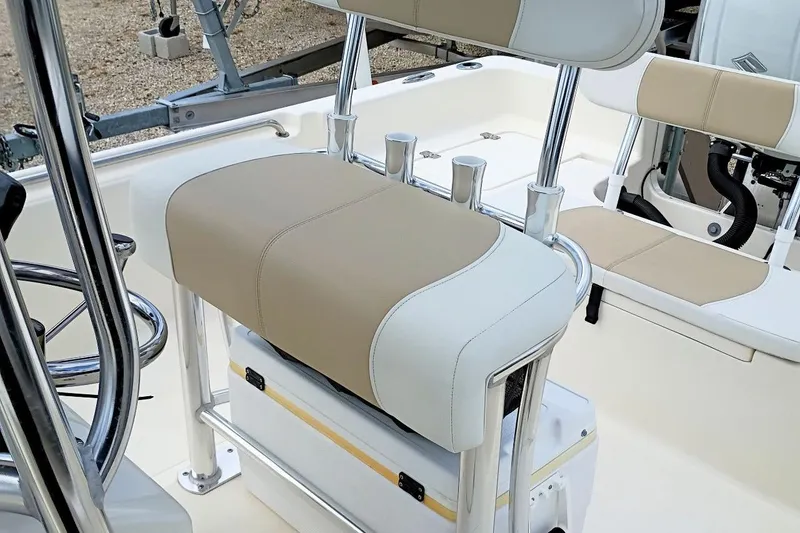 Slide: The Image of 2023 Bulls Bay 2200 boat interior with beige and white seating, featuring rod holders and steering wheel. - 30