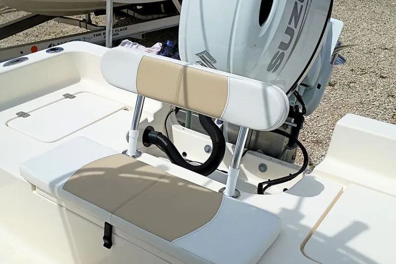 Slide: The Image of 2023 Bulls Bay 2200 boat interior with beige and white seating, Suzuki engine visible. - 31