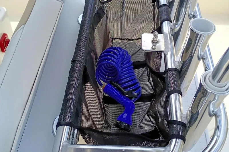 Slide: The Image of Blue coiled hose in storage compartment of 2023 Bulls Bay 2200 boat. - 32