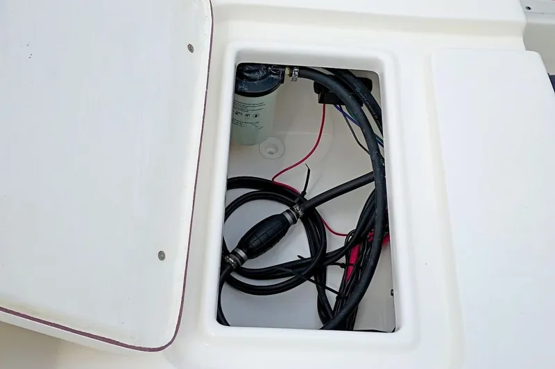 Slide: The Image of Open compartment of 2023 Bulls Bay 2200 boat showing wiring and components. - 35