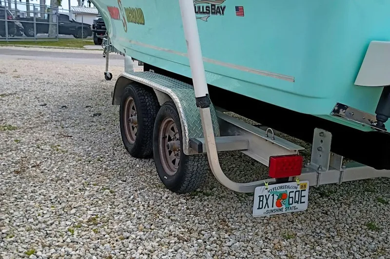 Slide: The Image of Trailer with 2023 Bulls Bay 2200 boat, Florida license plate, parked on gravel. - 46