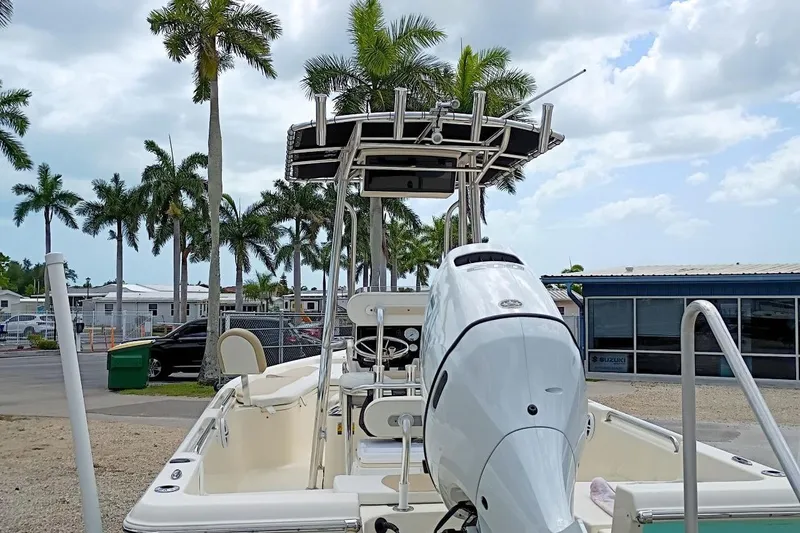 Slide: The Image of 2023 Bulls Bay 2200 boat with outboard motor, parked near palm trees and buildings. - 5
