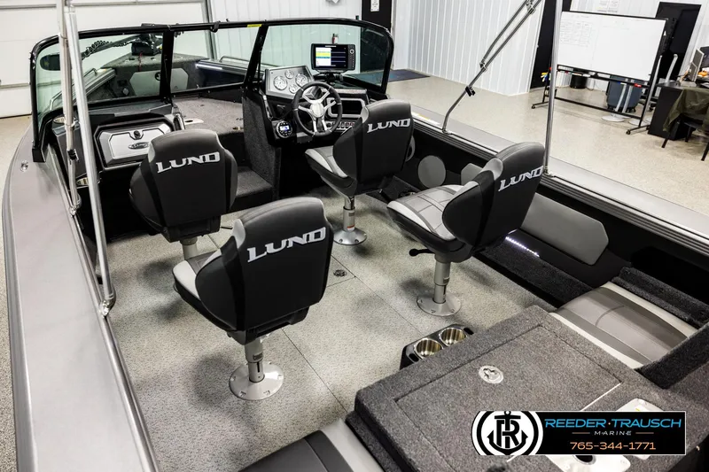 Slide: The Image of 2023 Lund 1875 Tyee boat interior with four seats and modern dashboard. - 11