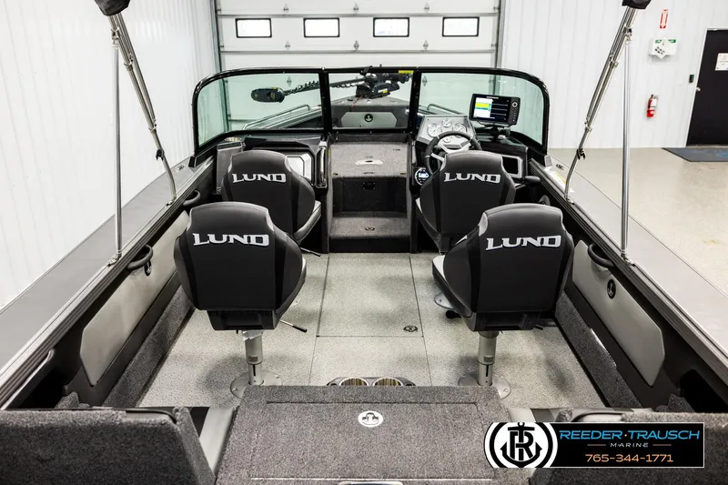 Slide: The Image of Interior view of 2023 Lund 1875 Tyee boat with four branded seats and modern dashboard. - 13