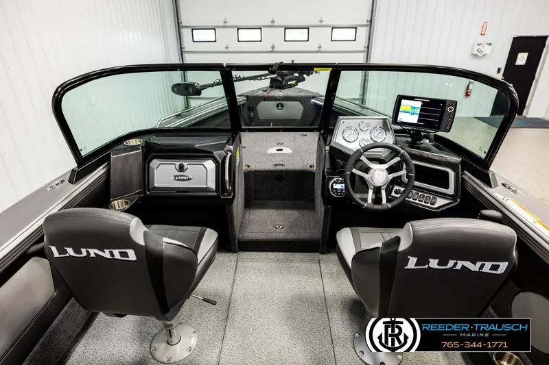 Slide: The Image of 2023 Lund 1875 Tyee boat interior with steering wheel, dashboard, and seating. - 14