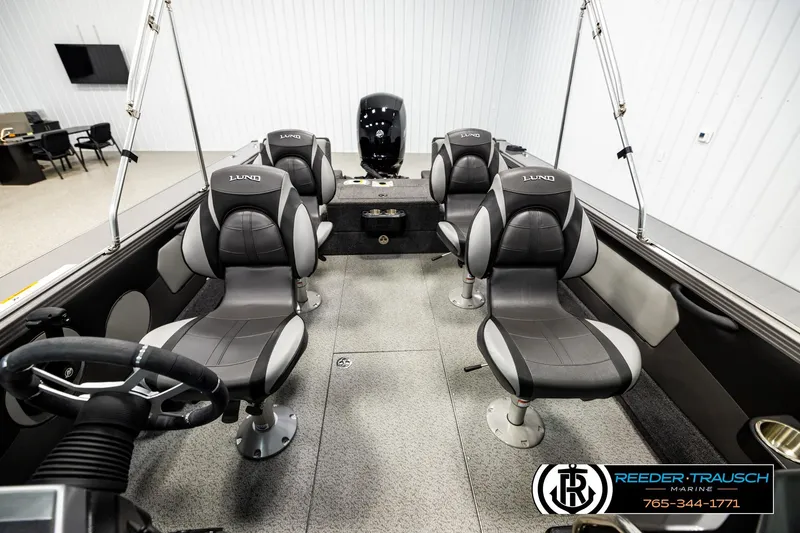 Slide: The Image of Interior of 2023 Lund 1875 Tyee boat with four cushioned seats and steering wheel. - 17