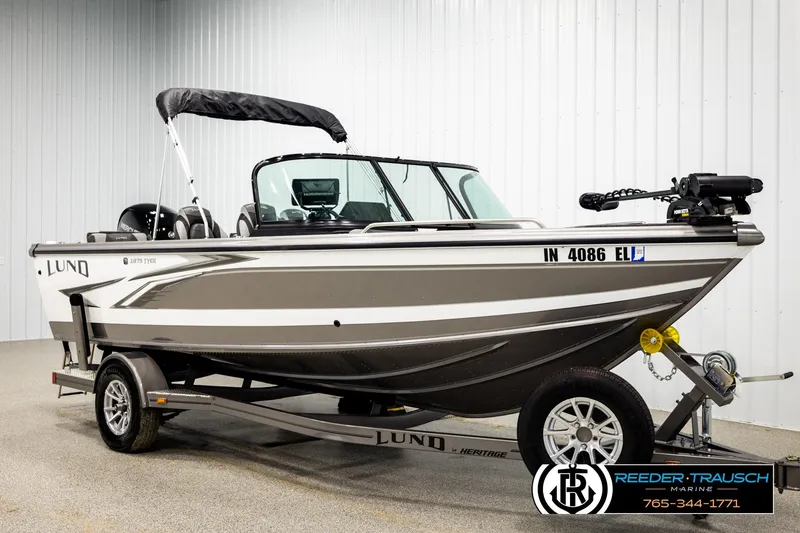 Slide: The Image of 2023 Lund 1875 Tyee boat on trailer in showroom, side view. - 2