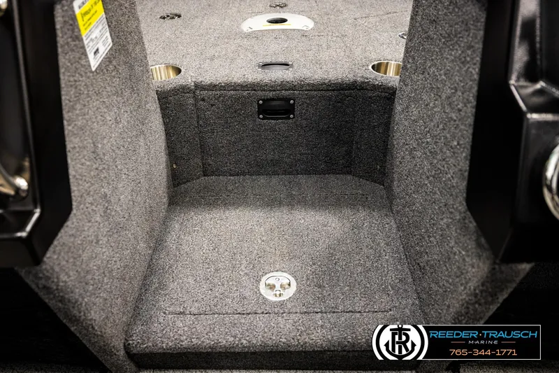 Slide: The Image of 2023 Lund 1875 Tyee boat interior with carpeted flooring and cup holders. - 24