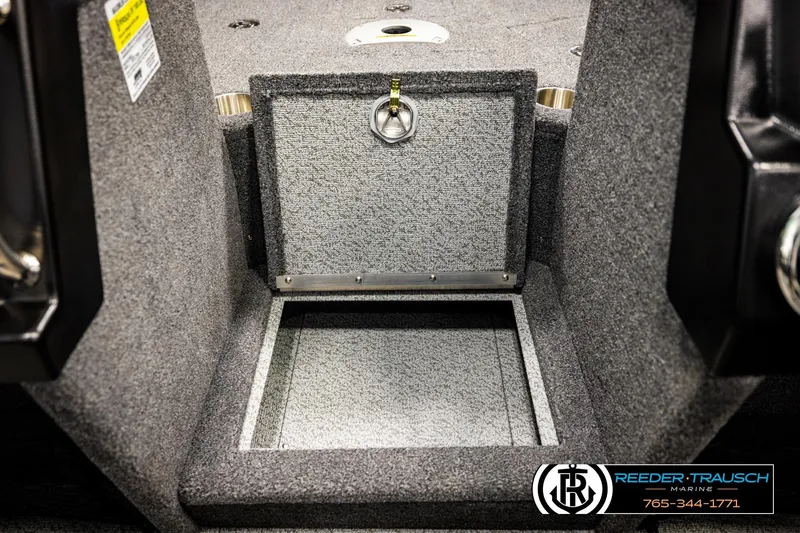 Slide: The Image of 2023 Lund 1875 Tyee boat storage compartment with open hatch, carpeted interior. - 25