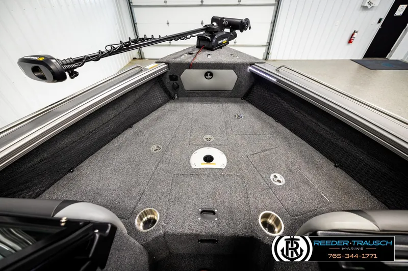 Slide: The Image of 2023 Lund 1875 Tyee boat interior with carpeted deck and fishing rod holder. - 26