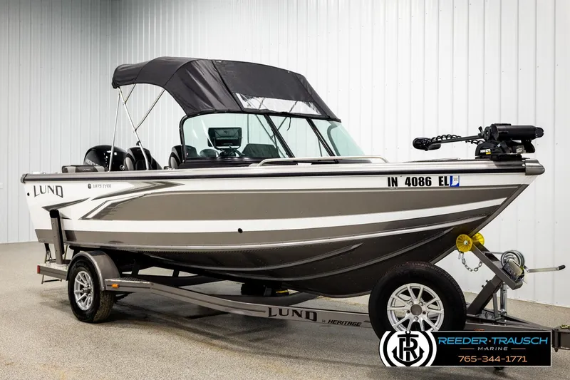 Slide: The Image of 2023 Lund 1875 Tyee boat with canopy on trailer in showroom. - 3