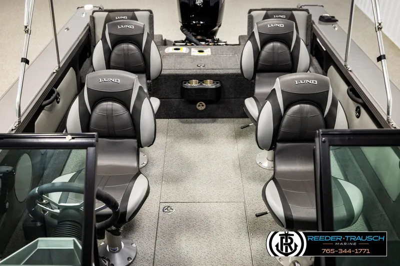 Slide: The Image of 2023 Lund 1875 Tyee boat interior with gray seating and steering wheel. - 30