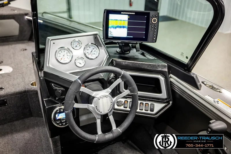 Slide: The Image of 2023 Lund 1875 Tyee boat dashboard with steering wheel and electronic display. - 36