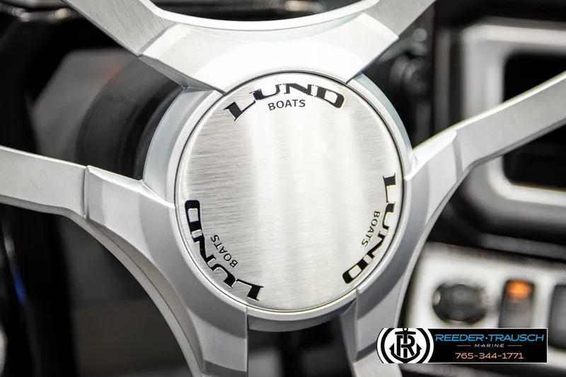 Slide: The Image of Steering wheel of 2023 Lund 1875 Tyee boat, featuring sleek metallic design. - 37