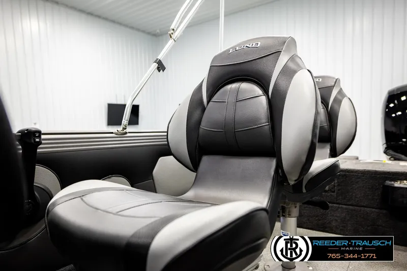 Slide: The Image of 2023 Lund 1875 Tyee boat interior with comfortable seating in a showroom. - 44