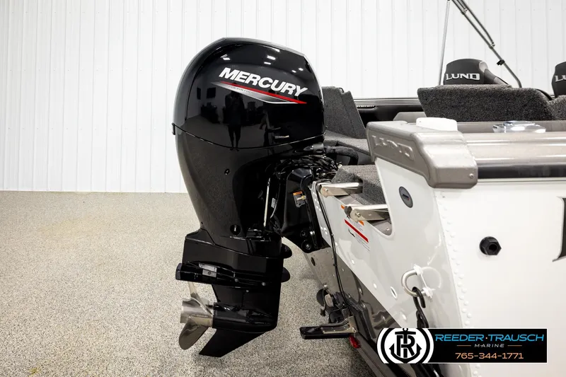 Slide: The Image of 2023 Lund 1875 Tyee boat with Mercury outboard motor, displayed indoors. - 55