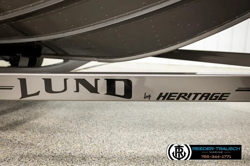 Slide: The Image of 2023 Lund 1875 Tyee boat trailer by Heritage, Reeder-Trausch Marine branding visible. - 62