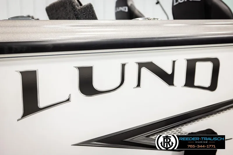 Slide: The Image of 2023 Lund 1875 Tyee boat detail with logo and Reeder-Trausch Marine branding. - 63