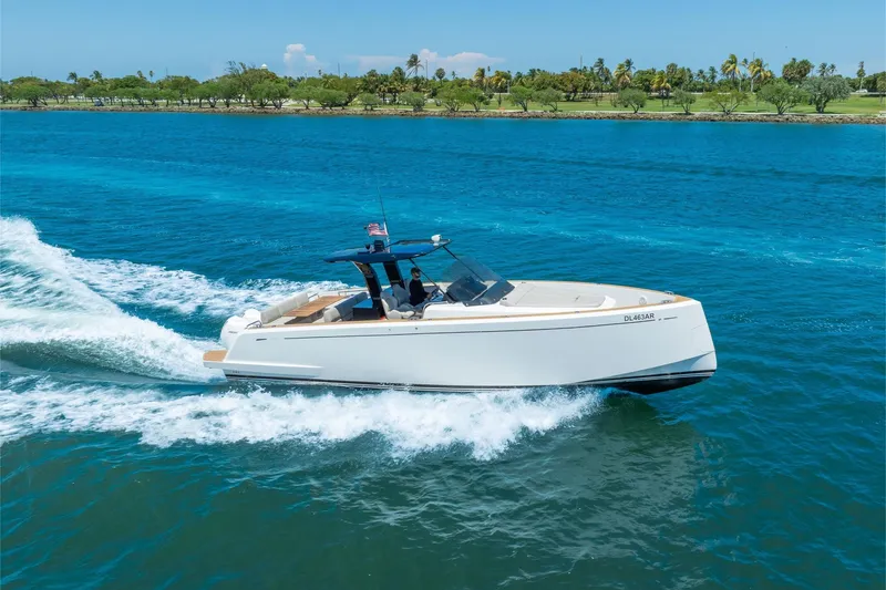 The Image of 2020 Pardo Yachts 38 cruising on blue water near a lush shoreline. - 0