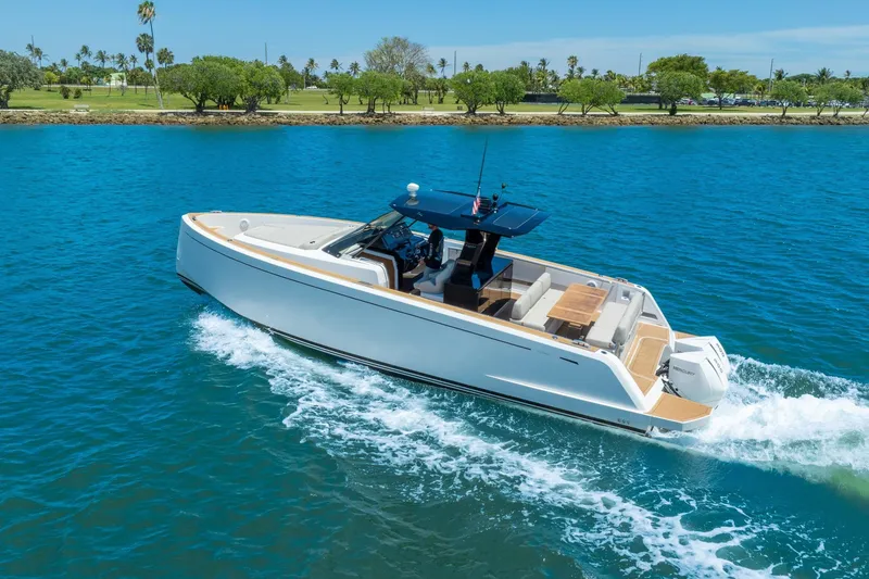 Slide: The Image of 2020 Pardo Yachts 38 cruising on blue water near a lush green shoreline. - 10