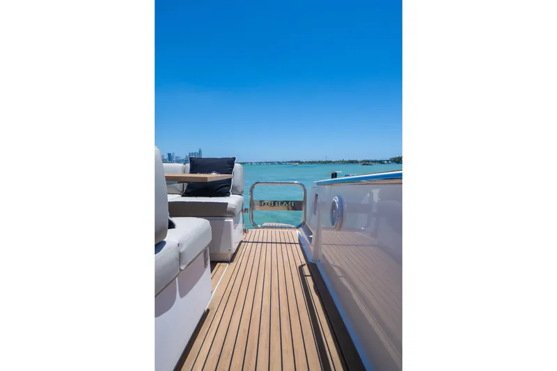Slide: The Image of 2020 Pardo Yachts 38 deck with seating, overlooking clear blue water. - 15