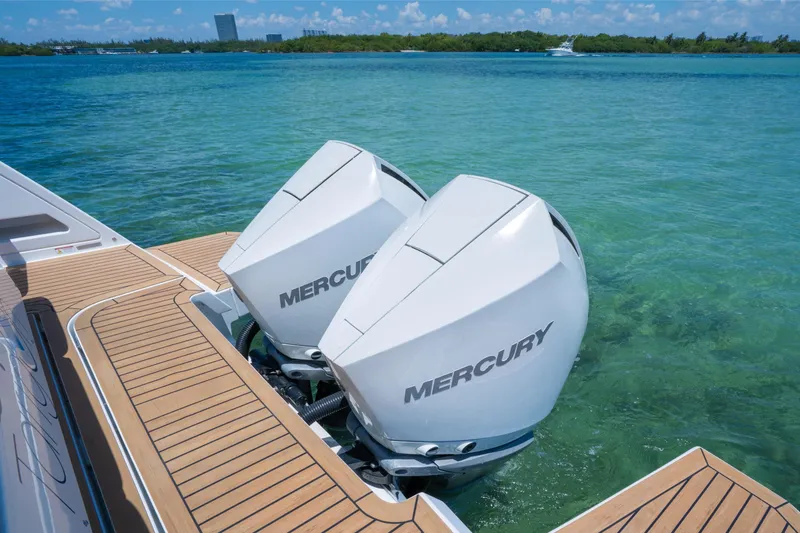Slide: The Image of Twin Mercury outboard engines on a 2020 Pardo Yachts 38, docked in clear blue water. - 16